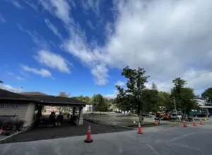Blacktop Services crew repaving and compacting a commercial bank parking lot in Worcester County MA ahead of high-traffic fall shopping